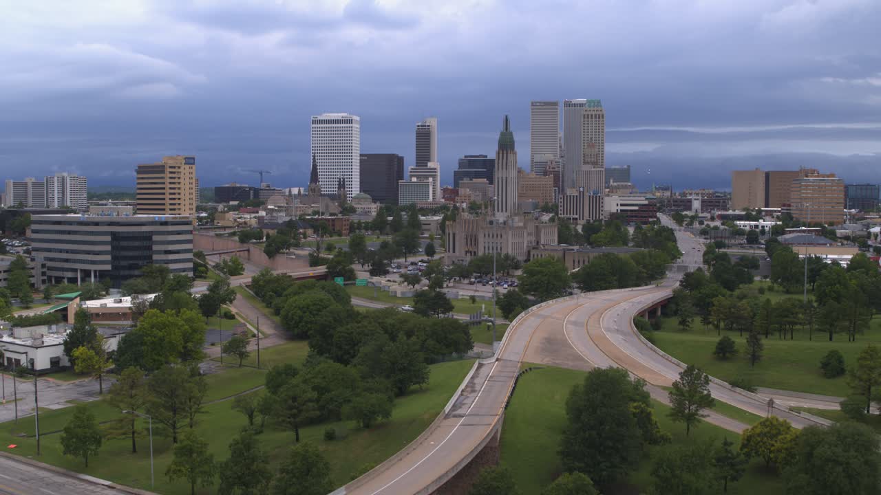 Drone view of Tulsa, Oklahoma downtown cityscape area with surrounding terrain