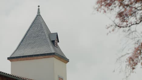 Historic-tower-with-a-pointed-roof-and-a-small-dormer-window-in-Toulouse,-France