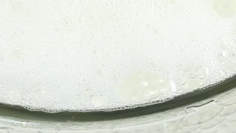 group of millions of bubbles growing, reacting and exploding in a transparent glass jar