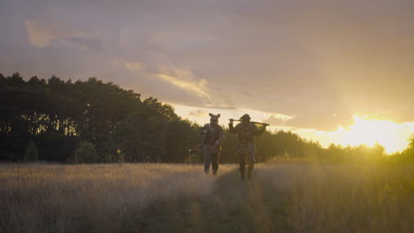 two hunters in camouflage at sunset