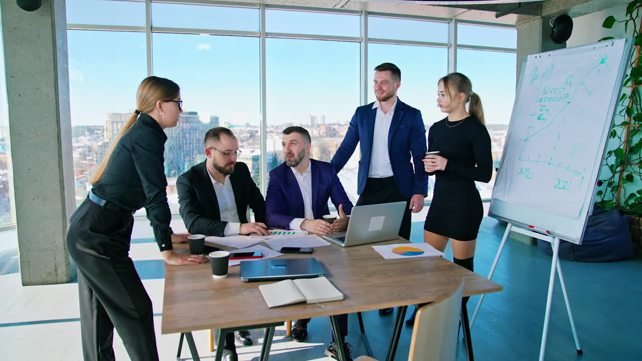 Business meeting in modern office. Group of diverse colleagues in formal clothing discussing business ideas