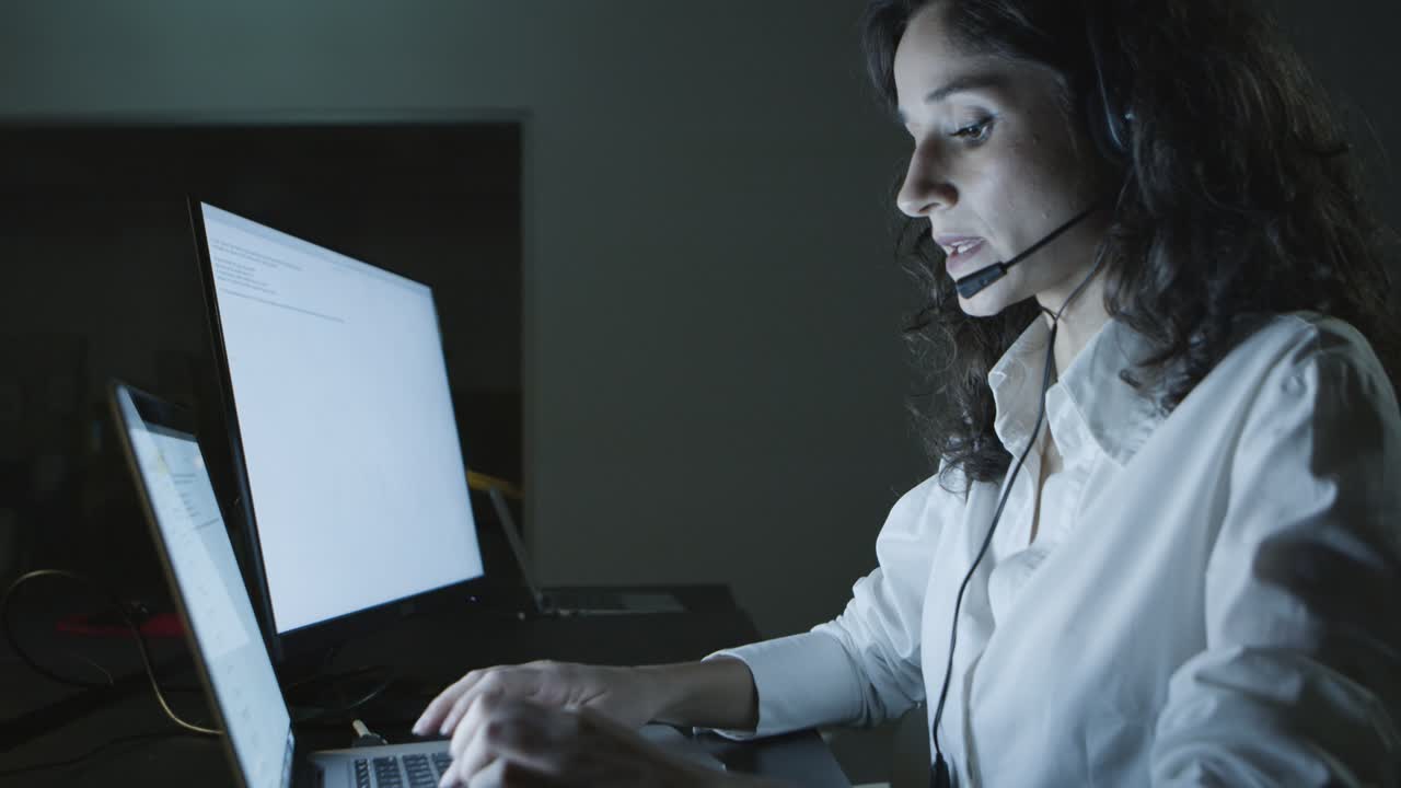 Teleworker talking and typing on laptop
