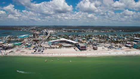 drone aerial flyover of fort myers beach full of people