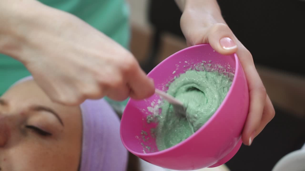Relaxing girl in spa salon. Young beautiful girl in mask for face relaxing in spa salon
