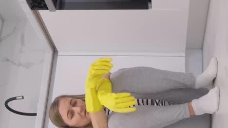 young lady is resting after cleaning the kitchen room