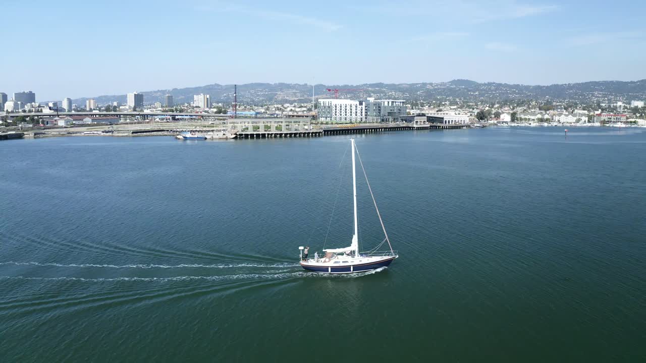 The camera slips alongside the sailboat in this beautiful troll along the estuary.