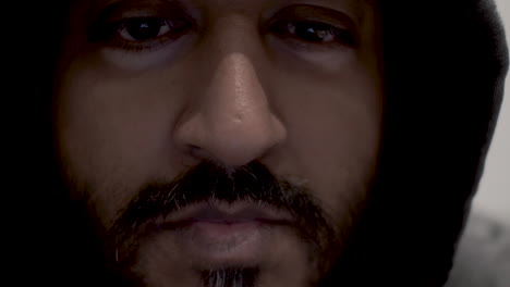 a close up dolly shot of the deep focused eyes of a hacker, concentrating on the malicious firewall attack code displayed on his computer screen