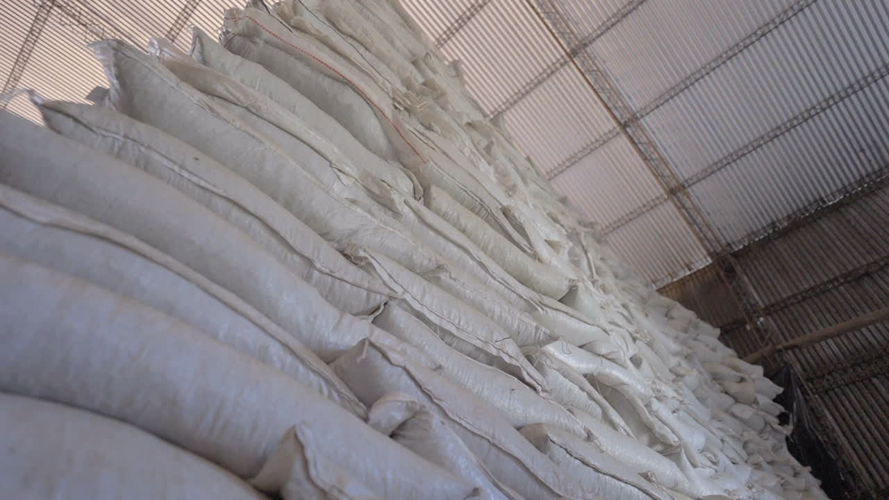 Stacked Bales of Dried Yerba Mate Leaves, Industrial Herbal Processing Facility