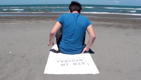 Young-Man-Slepping-On-The-Beach