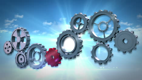 Cogs and wheels turning against blue sky