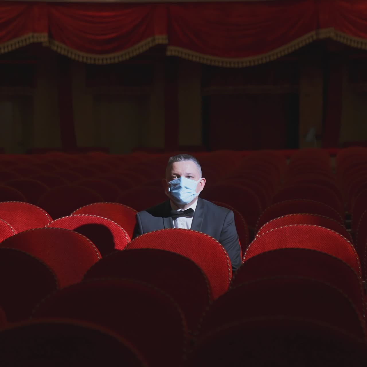 Lonely man sitting on theater seat