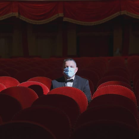 lonely man sitting on theater seat