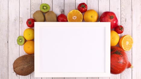 white frame with place for text and moving fruits and vegetables under frame. stop motion
