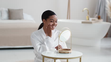 woman applying skincare in luxurious bathroom