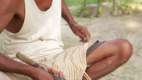 asiatic male artisan making crafting hat with bamboo close up on skilled hands