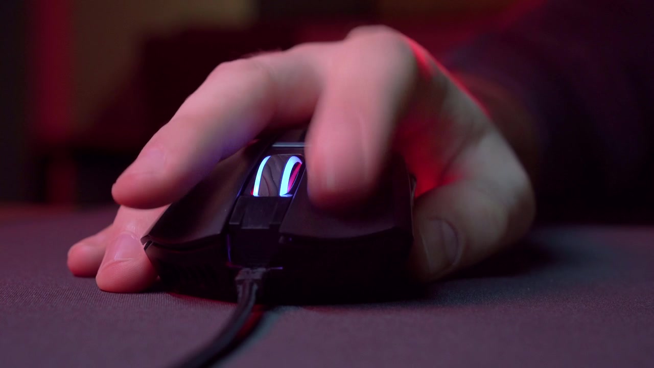 Close-up of Hand Clicking and Scrolling a Gaming Mouse with RGB Lighting