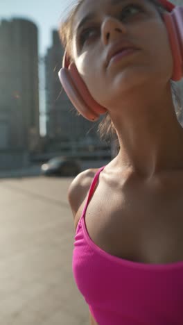 young woman listening to music outdoors