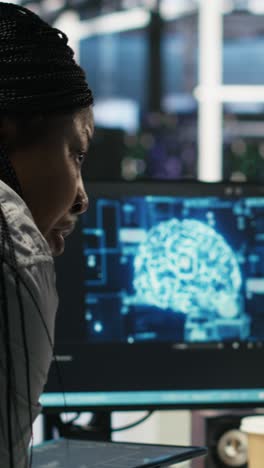 vertical video data center engineer in wheelchair and colleague oversee ai automated tasks