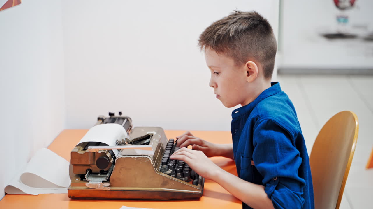 boy working on typewriter