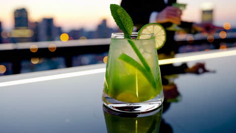 colorful cocktails on a rooftop bar with a city view