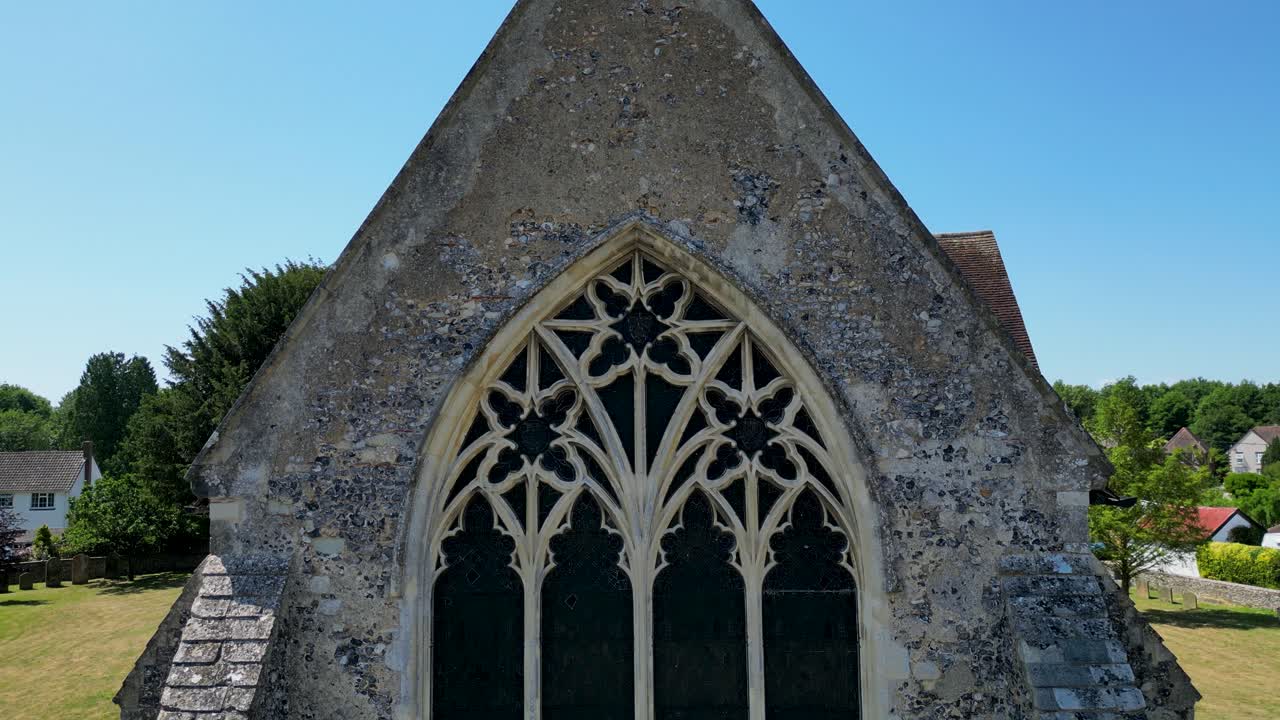 Rising boom-shot of St Mary's church in Chartham, rising in front of the main window, then to reveal a cross and the rear tower