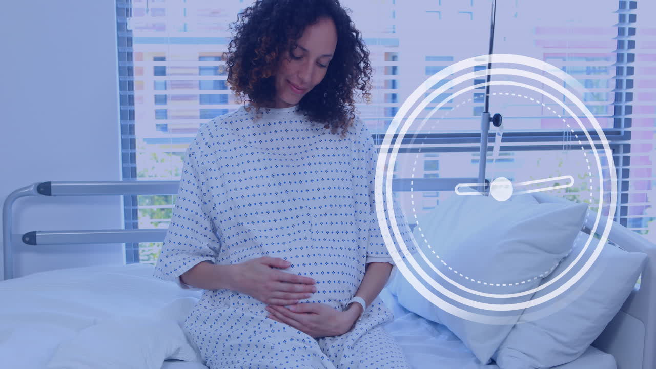 Fast moving clock over happy pregnant biracial woman rubbing belly in hospital room
