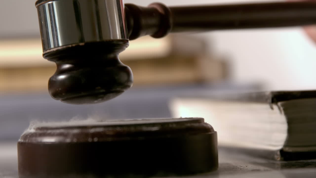 martillo cayendo en el bloque de sonido al lado de los libros