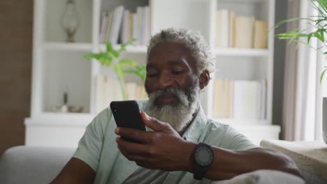 Video-of-african-american-senior-man-using-smartphone