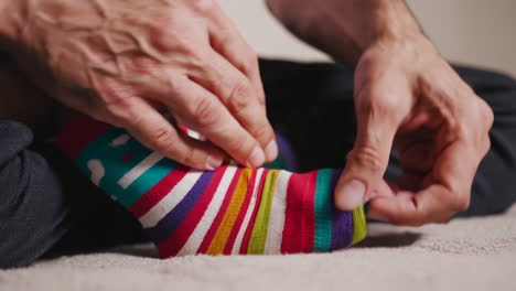 person folding colorful striped socks