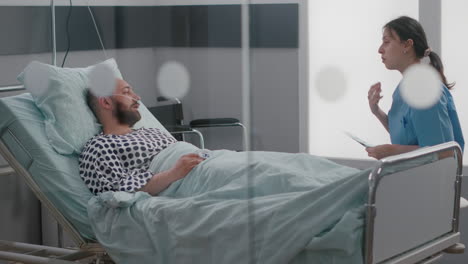 medical nurse explaining bones radiography to hospitalized sick man