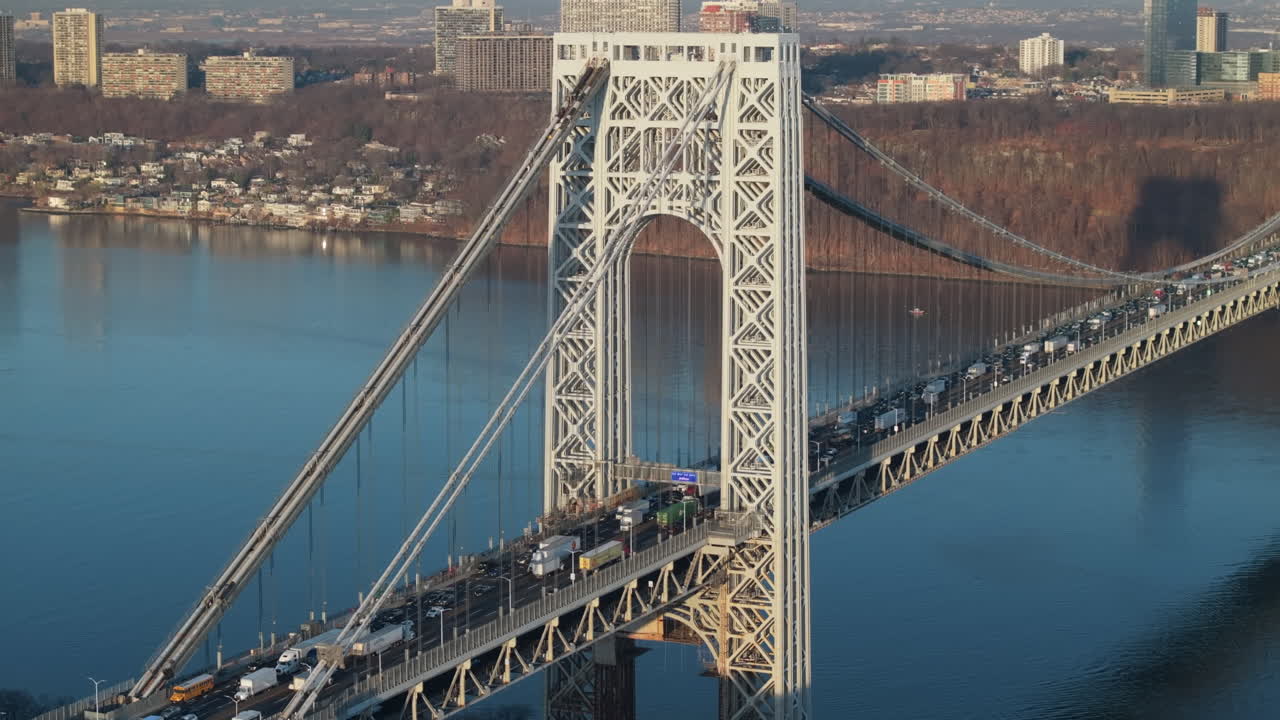 Aerial view of rush hour traffic crossing New York City’s George Washington Bridge. Shot at sunrise.