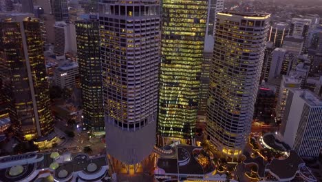 Tilting-down-aerial-view-of-skyscrapers-at-sunset