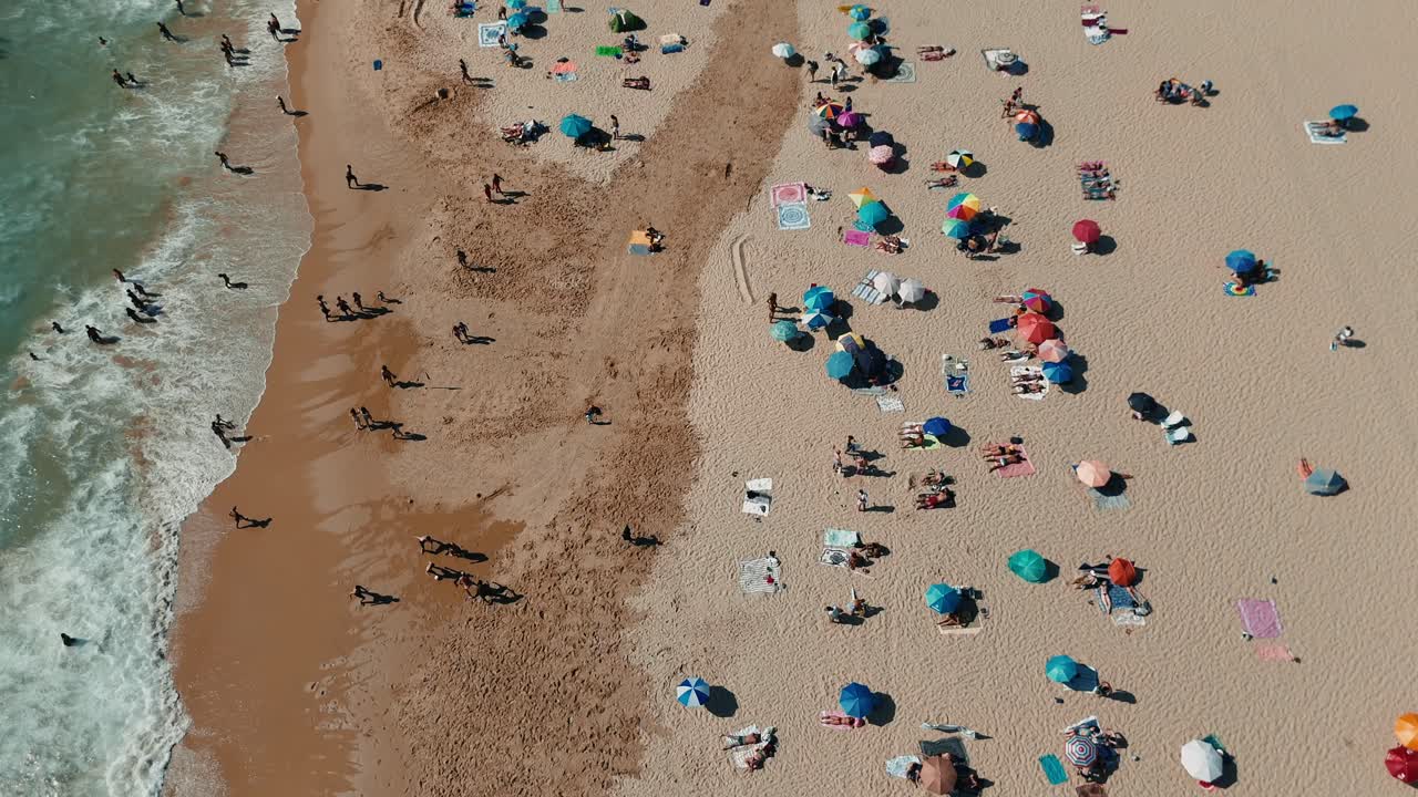 Aerial View of Beach with People and Umbrellas