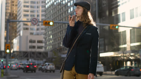 side view of young caucasian man talking on mobile phone in the city 4k