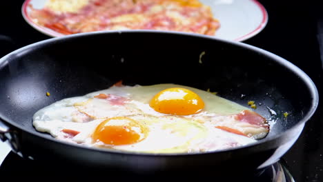 cooking sunny side up 2 fresh eggs in a pan