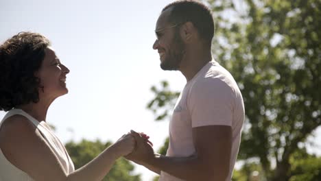 pareja alegre saludándose en el parque