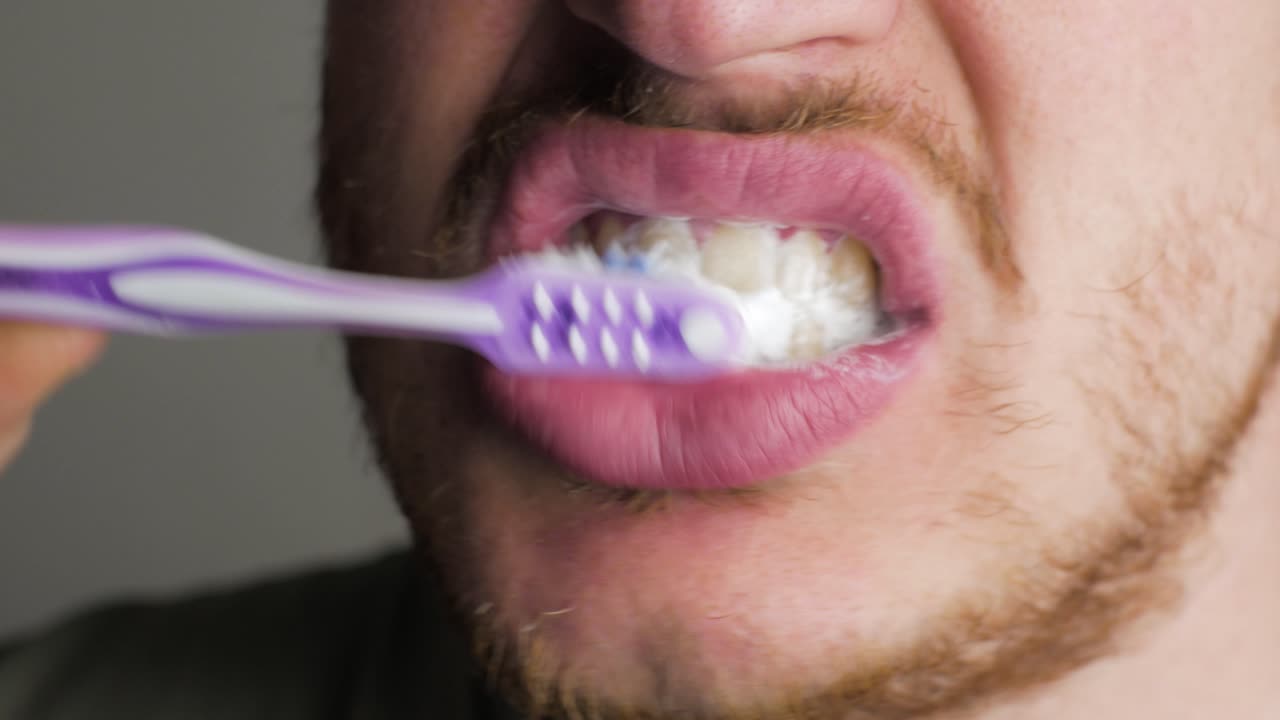brushing the teeth of a male adult