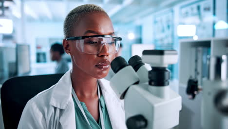 female scientist using microscope in a laboratory