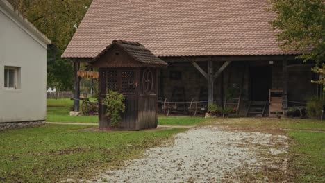 old wooden house and barn in a rural setting