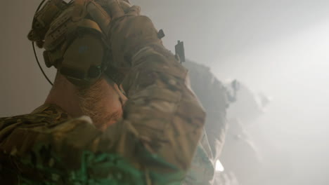 soldiers in camouflage uniform wearing helmets and getting ready for airsoft military game