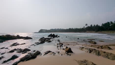 scenic coastal view of white frothy rolling waves with rocky shoreline in southern province of sri lanka