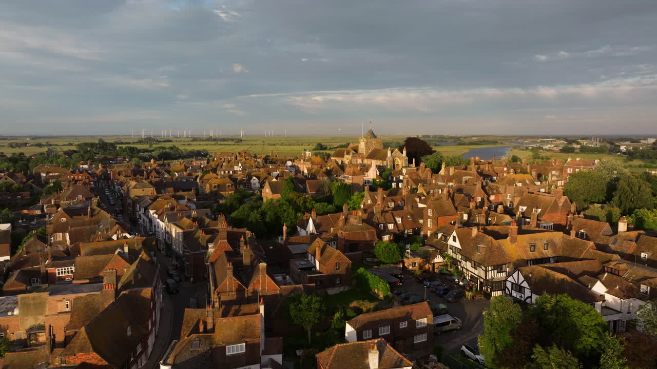 Panorama Of Rye Town During Sunset With Rural And Wind Farm In The Distance In East Sussex, England, UK. - aerial shot