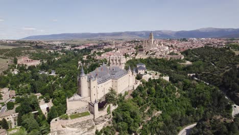 Aerial wide: Alc&aacute;zar de Segovia with Cathedral in backdrop, highlighting historical allure, Spain