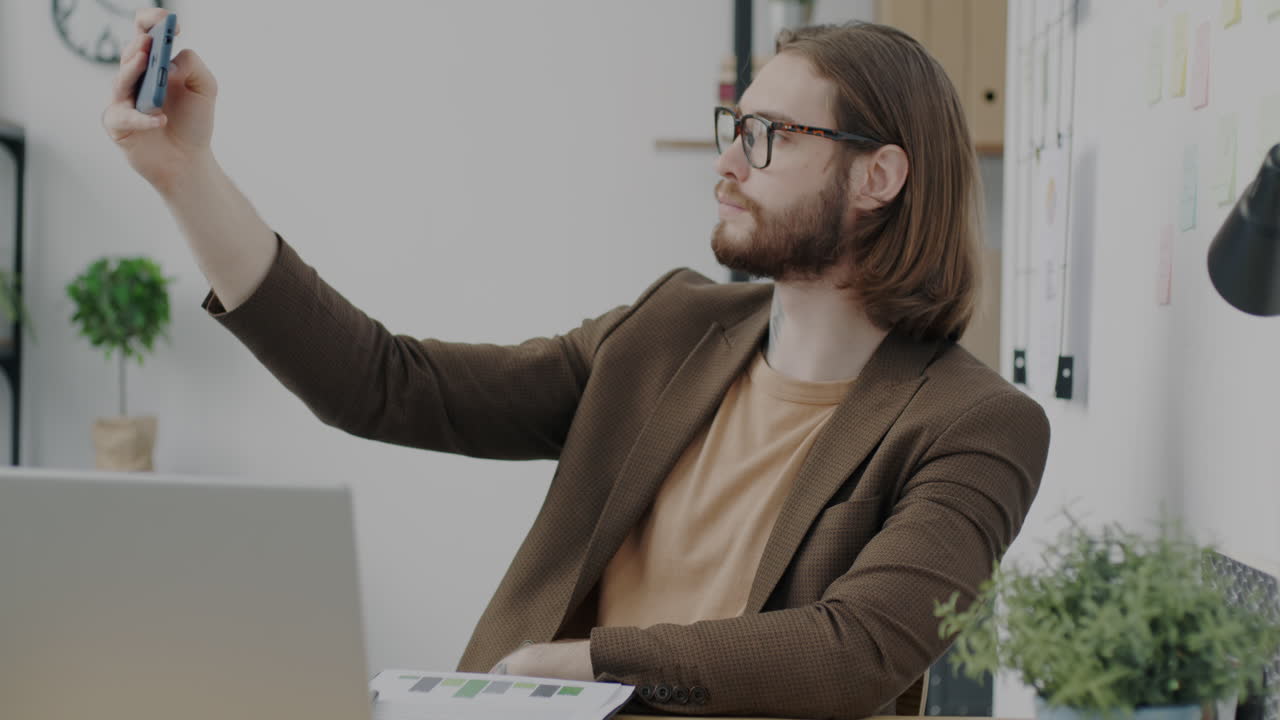 Man Taking a Selfie in Office