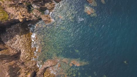 aerial: beautiful rocky cornwall coastline, uk, top down view