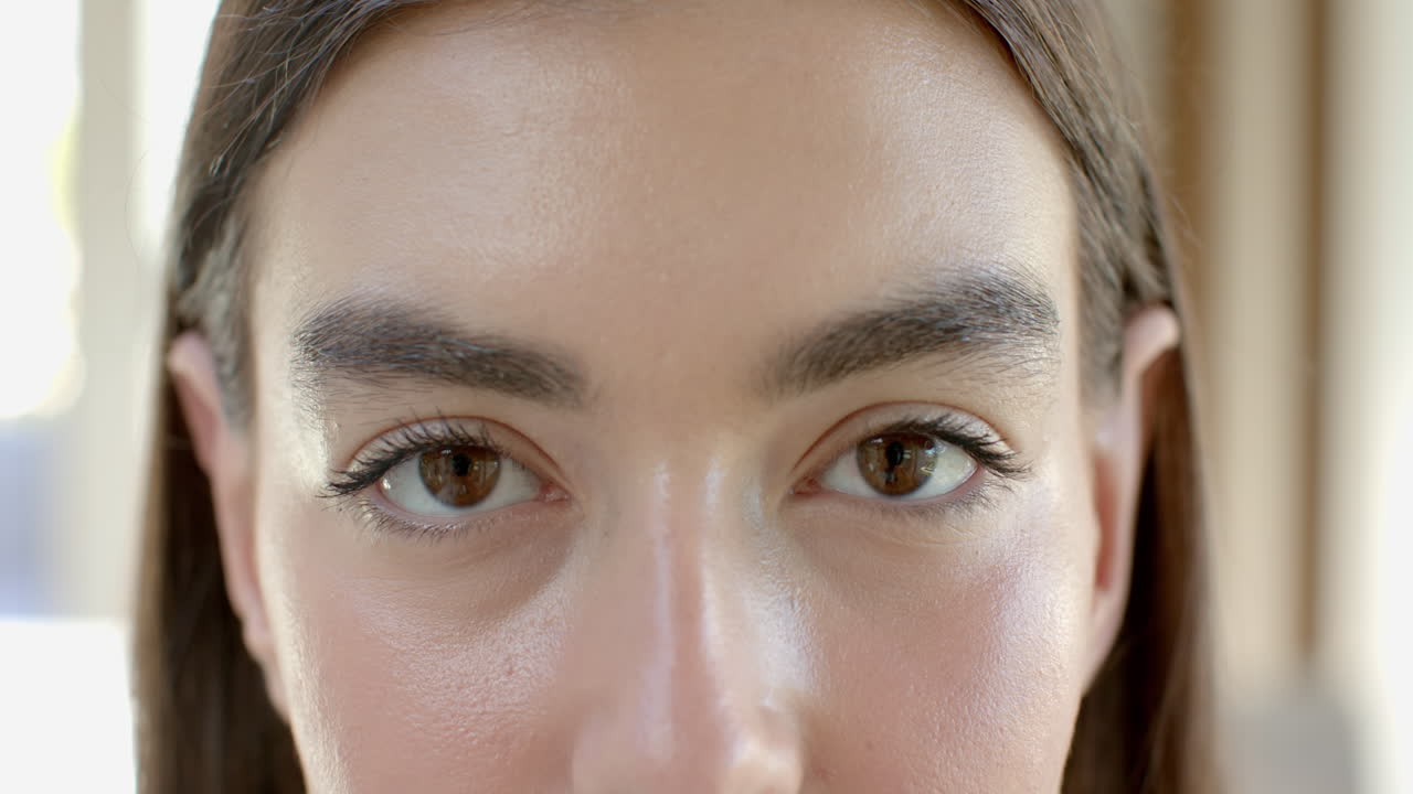 Close-up of a teenage Caucasian girl with brown eyes and prominent eyebrows