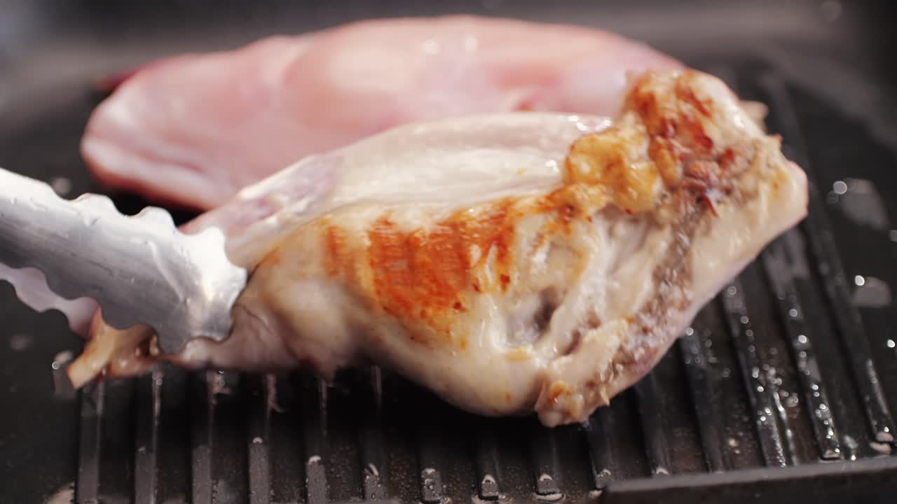 Roasted rabbit legs in a grill pan, healthy diet meat close up, chef cooking rabbit on kitchen restaurant, Black background. Top view