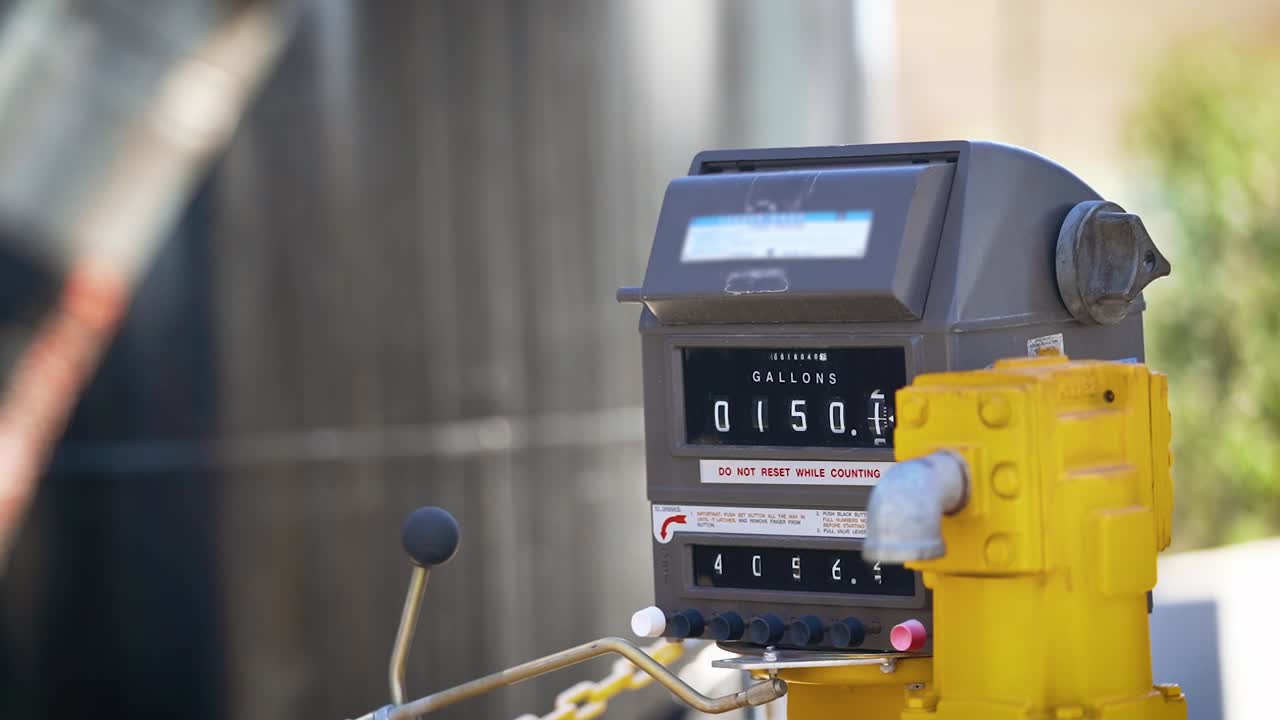 Oil and gas pump filling up counting gallons counting slow motion push in