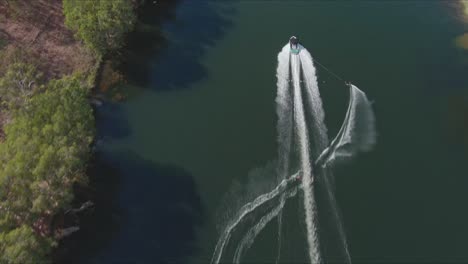 following a water skier during a slalom competition