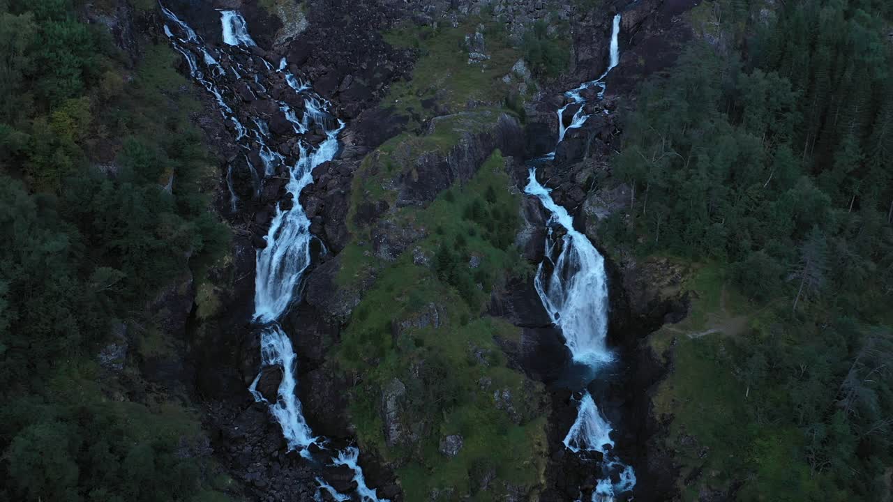 Latefoss waterfall during at dusk - Dark moody upward moving aerial of tourist attraction Latefoss waterfall in Hardanger